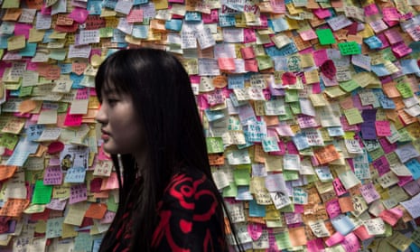 Woman walks past wall of messages