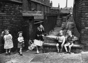 Children play in the alleys behind their terraced houses in Salford, Manchester. 1962.