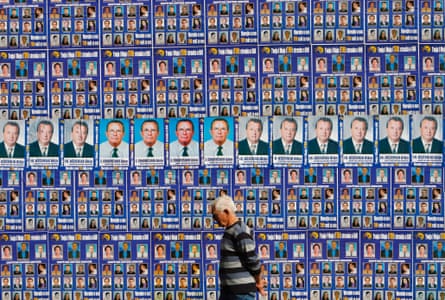 A man walks past a wall decorated with posters of political parties and candidates for the parliamentary elections in central Sarajevo September 28, 2010.