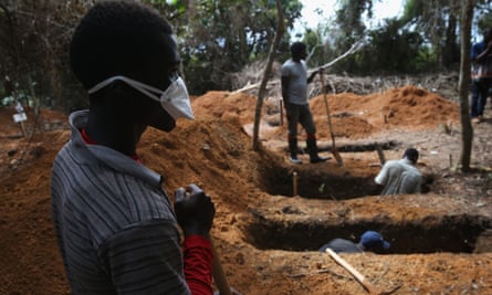 Grave diggers prepare for new Ebola victims outside an Ebola treatment centre near Gbarnga, central Liberia.