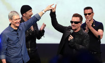Apple CEO Tim Cook, left, greets Bono after U2's performance at the launch of the iPhone 6 in California last month.