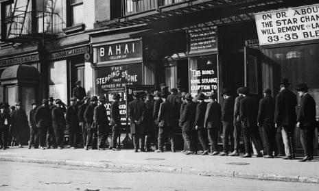 Unemployed men queuing for coffee and bread at a soup kitchen in New York, circa 1930.