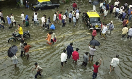People walk through water after heavy rains in July, 2005.