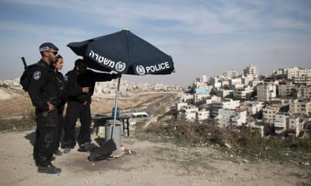 Israeli Border Police take position on a hill overlooking the east Jerusalem Arab neighborhood of Issawiya today