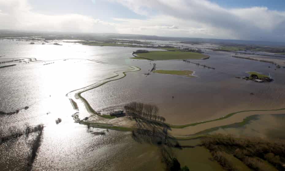 Water surrounding flooded properties on the Somerset Levels near Bridgwater as a study by the European Environment Agency (EEA) has found that extreme weather conditions such as floods and heatwaves are pushing countries across Europe into taking action to adapt to a changing climate.