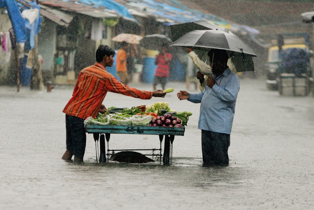 Business as usual ... a man buys vegetables on a flooded Mumbai street.