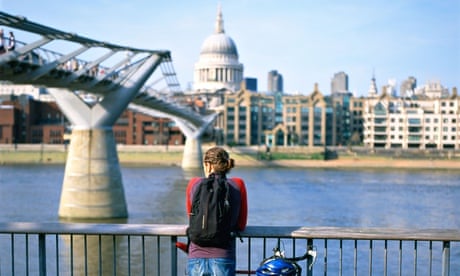 A cyclist by the Millennium Bridge in London