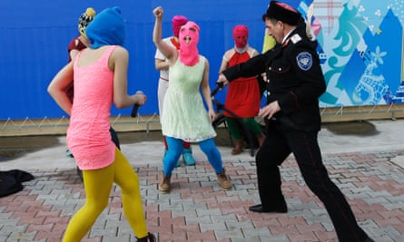 Members of the punk group Pussy Riot, including Nadezhda (Nadya) Tolokonnikova in the blue balaclava and Maria Alyokhina in the pink balaclava, are attacked by Cossack militia in Sochi, Russia, on 19 February 2014.