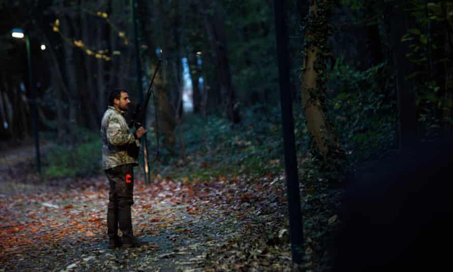 A member of the police animal brigade walks through a wood in Montevrain