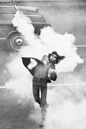 5 May 1970: A man at the University of California, Berkeley, throws a tear gas canister at police during a student strike to protest against the killing of four students at Kent State University. The Berkeley demonstration was one of many across the nation in direct response to the killings by National Guardsmen during an anti-Vietnam War demonstration the previous day