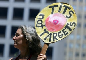 30 June 2005: Berkeley resident Jackie Barshak holds a sign protesting against the war in Iraq in Union Square, San Francisco. A dozen men and women took their tops off to protest against the war