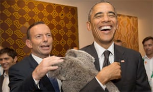 Barack Obama cuddles a koala, watched by Tony Abbott, the Australian prime minister.