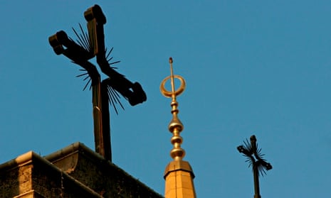 Mosque's minaret and cathedral's crosses