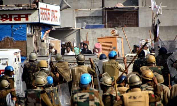 Indian security forces face supporters of Rampal Maharaj at their compound in Hisar