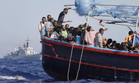 Migrants are taken to the mainland after being rescued by an Italian navy boat.