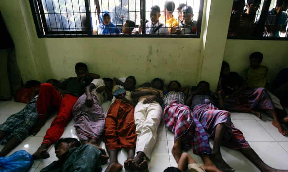 Rohingya refugees sleep on the floor of the immigration office in Lhok Seumawe, northern Aceh, Indonesia, in February 2013. They were part of a group of 120 Rohingya refugees, including six woman and two children, were rescued by fisherman after getting stranded at sea while heading for Australia.