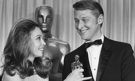 Leslie Caron presents Mike Nichols with his Oscar.