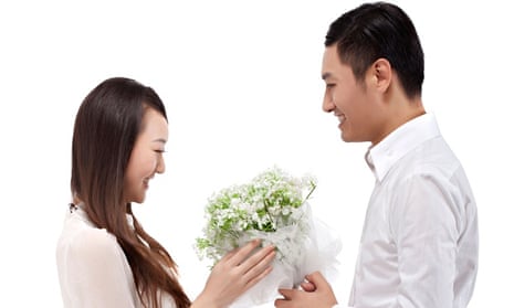 Young man gives his girlfriend flowers