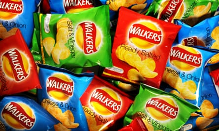 Lots of packets of Walkers cheese and onion, ready salted and salt and vinegar crisps.