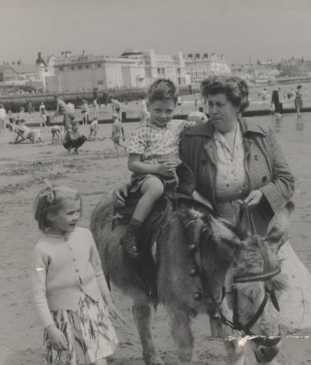 David Hayes rides a donkey on Bridlington beach in 1962, accompanied by his mother and sister.
