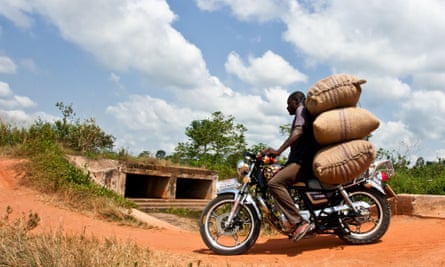 A man transports cocoa beans on a motor cycle in Abengourou, Ivory Coast.