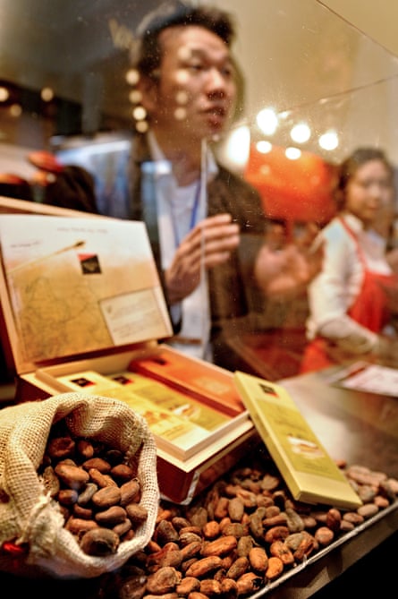 A man talks to visitors at a stall of the Salon du Chocolat in Shanghai.