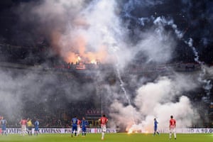 Croatia fans throw flares on to the pitch at the San Siro stadium during a football match against Italy. The Euro 2016 qualifier was temporarily stopped in both halves by the Dutch referee Bjorn Kuipers. Croatia midfielder Luka Modric said: “It’s always the same and I do not understand why they do it. It’s a shame to have fans like that. I do not know why they continue to behave like this. It’s madness”