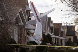 A small cargo plane is photographed after crashing into the side of a house in Chicago. The pilot died instantly but the inhabitants sleeping in an adjacent bedroom escaped injury
