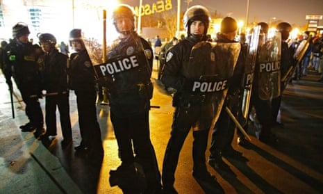 Police rush in to break up protesters outside the Ferguson police station in Ferguson, Missouri, 20 November 2014.