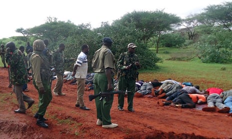 Security forces near victims killed in the dawn attack on a bus near Mandera, in which 28 non-Muslim