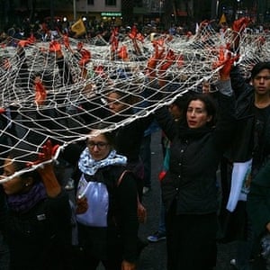 Demonstrators protesting with red hands and giant net   Mexico city, 20 November, against the disappearance of 43 student protesters