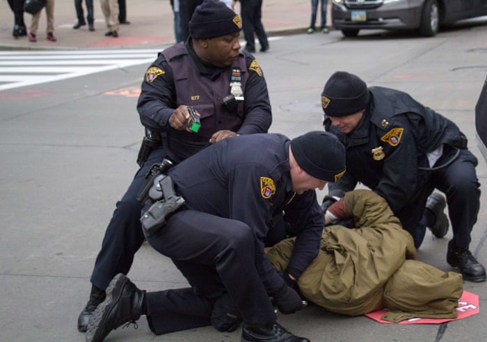 Cleveland police arrest a protester in Cleveland, Ohio during a demonstration in which they blocked the roads leading to Public Square November 25, 2014.