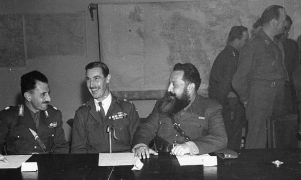 Lt Gen Ronald Scobie with two other military men at a desk. On 5 December 1944, imposed martial law and ordered the aerial bombing of the working-class Metz quarter of Athens.