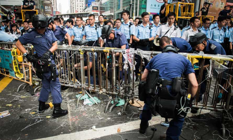 Officers dismantle barricades in Mong Kok.