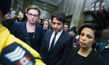 Radio host Jian Ghomeshi (centre) leaves court after getting bail at a brief court appearance in Toronto.
