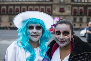 A couple of girls with their faces painted in the main square