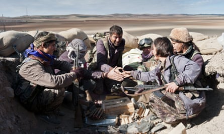 Kurdish fighters defend a position against encroaching Isis militants.