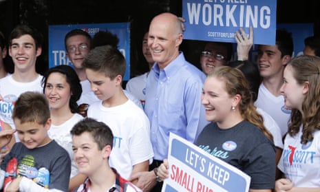 Rick Scott, centre, at a campaign stop earlier on election day.