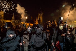 Protesters set off fireworks during the 'Million Mask March' outside Westminster's Parliament buildings