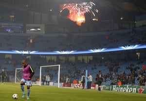 Manchester City's Fernando warms up with a firework display on the screen at the Etihad Stadium