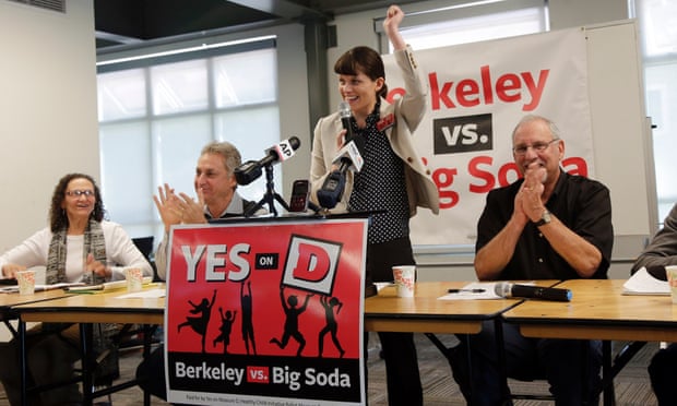 Campaign manager Sara Soka, center, celebrates with fellow supporters after the passing of Measure D, imposing a sales tax on soda drinks, in Berkeley