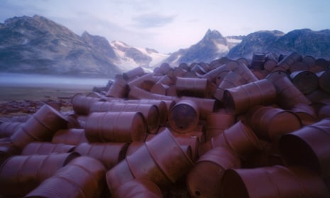 oil barrels in front of mountains 