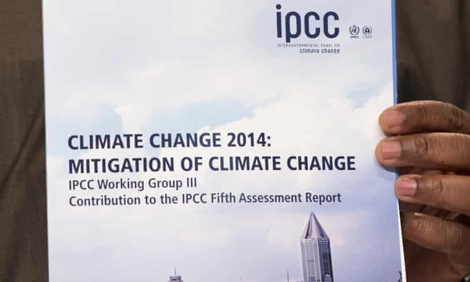 Youba Sakona, Coordinator of the African Climate Policy Centre (ACPC), poses with a copy of the IPCC report "Climate Change 2014, Mitigation of Climate Change" during a press conference in Berlin on April 13, 2014.