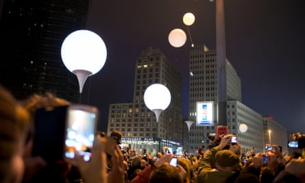 Illuminated balloons, part of the so-called Border of Light, rise into the sky at the Potsdamer Platz in Berlin.