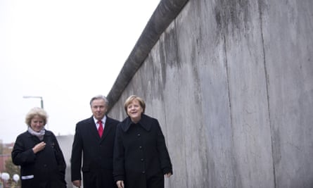 German chancellor Angela Merkel walks along a section of the former Berlin Wall during celebrations for the 25th anniversary of its fall.