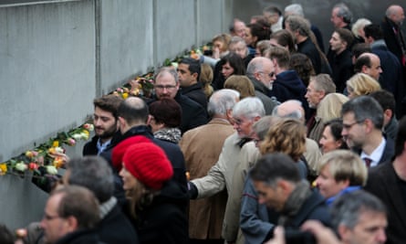 People attend a memorial activity to commemorate the 25th anniversary of the fall of the Berlin Wall.