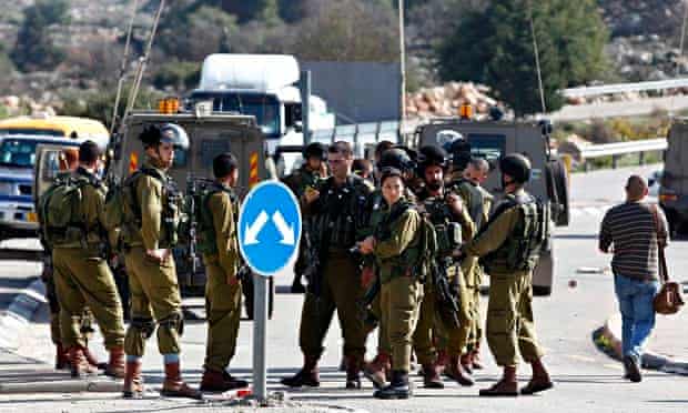 Israeli soldiers at the scene of a stabbing