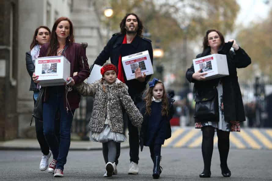 Russell Brand joins residents and supporters from the New Era housing estate in East London as they deliver a petition to 10 Downing Street.