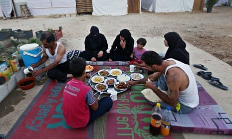 Syrian refugees eating at a refugee camp in Marj