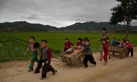 Schoolchildren help to fix potholes in a rural road in North Korea's North Hamgyong province. Outside the capital, most remain deep in poverty.